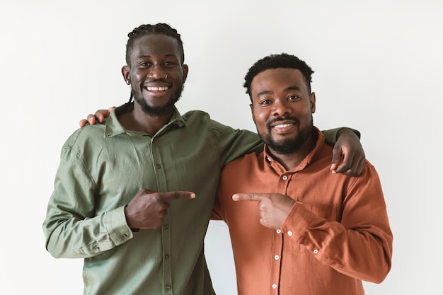 Two African Men Pointing Fingers At One Another White Background