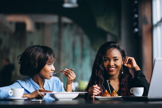 Two afro american women in a cafe at lunch