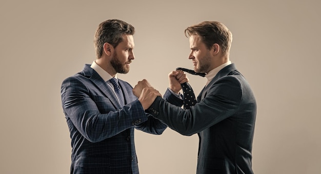 Two angry businessmen fighting and arguing having struggle for leadership on businessmeeting have business competition leadership