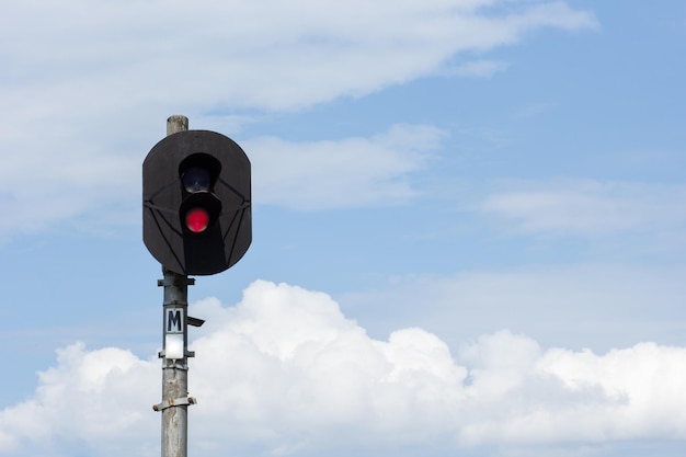 Two-aspect colour light railway signal with displayed red light set at danger and to stop over blue