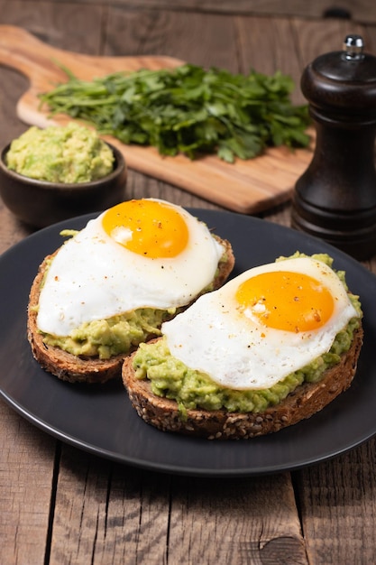 Two avocado open sandwiches with egg. Keto and diet concept. Healthy toast food for breakfast.