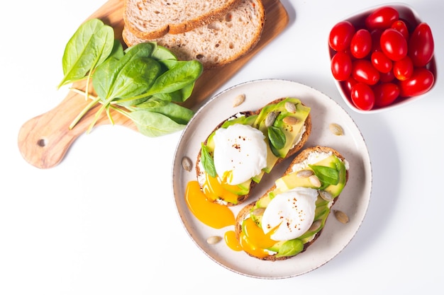 Two avocado open sandwiches with egg. Keto and diet concept. Healthy toast food for breakfast.