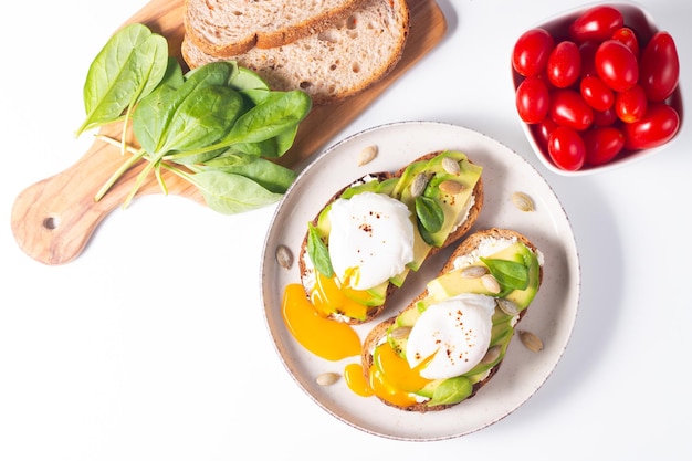 Two avocado open sandwiches with egg. Keto and diet concept. Healthy toast food for breakfast.