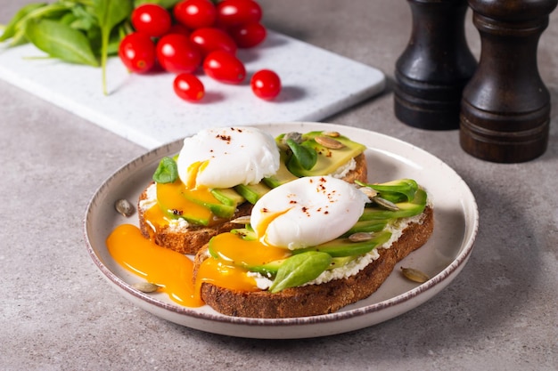 Two avocado open sandwiches with egg. Keto and diet concept. Healthy toast food for breakfast.