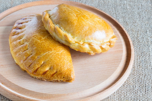 Two baked stuffed buns on the  cutting board