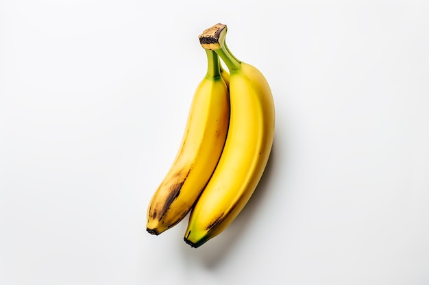 Two bananas are sitting on a white surface.