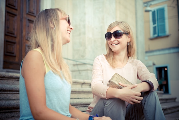 two beautiful blonde women talking 