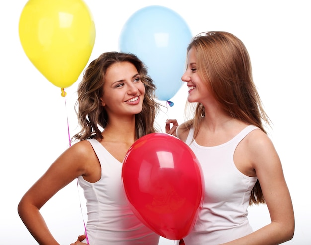 Two beautiful young girlfriends with color balloons