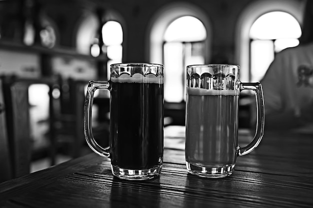 two beer mugs in a Czech beer restaurant / light and dark beer in large mugs traditional Prague pub