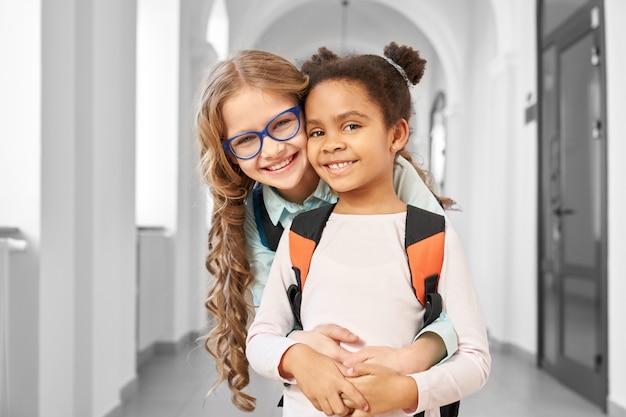 Two best friends at school corridor