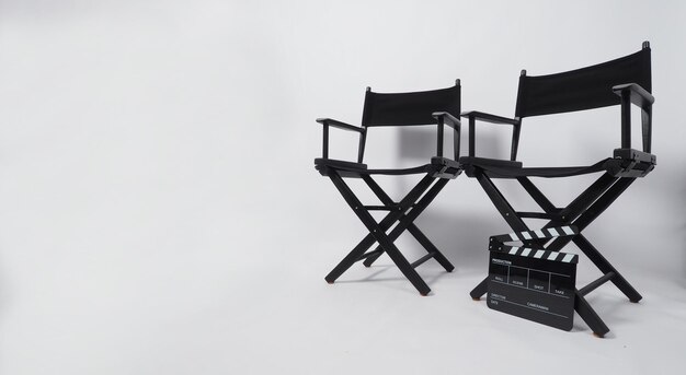 Two Black director chair and clapperboard on white background.