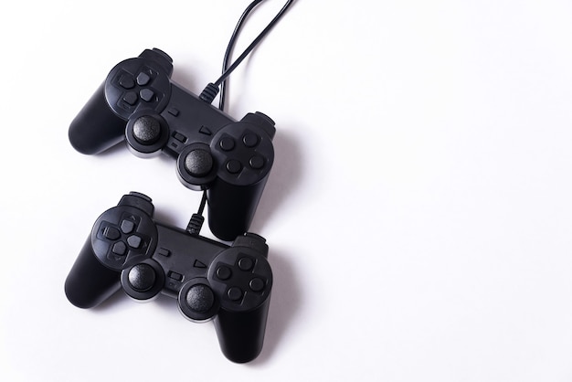 Two black gamepads on a white background