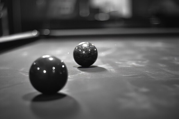 Two black and white balls sitting on top of a pool table