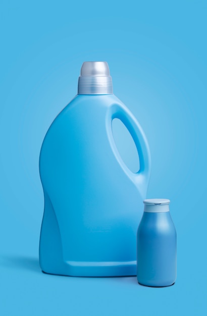 Two blue clear plastic bottles, without labels, on a blue background.