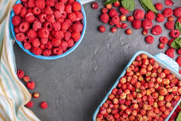 Two blue cups with raspberry and wild strawberry