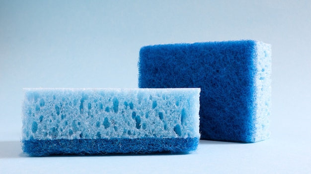 Two blue sponges used for washing and erasing dirt used by housewives in everyday life. They are made of porous material such as foam. Detergent retention, which allows you to spend it economically.