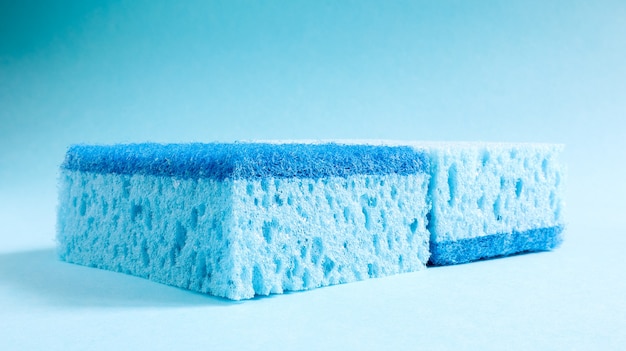 Two blue sponges used for washing and erasing dirt used by housewives in everyday life. They are made of porous material such as foam. Detergent retention, which allows you to spend it economically.