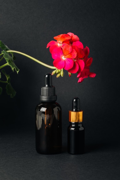 Two bottles of facial oil on a black background closeup