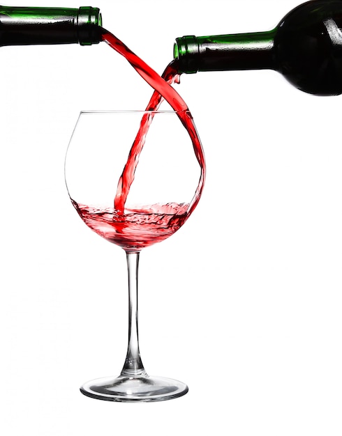  Two bottles pouring red wine in one glass