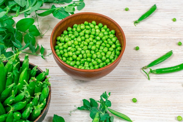 Two bowls of fresh young green peas