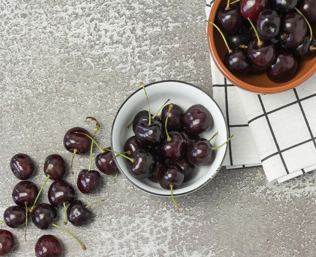 Two bowls with cherries on the table