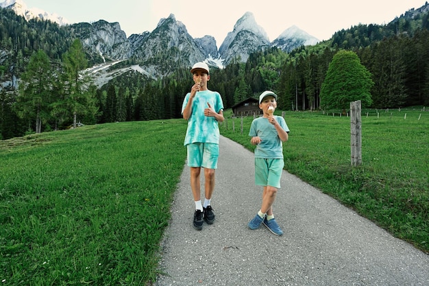 Two boys eat ice cream at Vorderer Gosausee Gosau Upper Austria