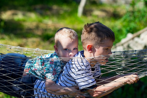 Two boys in a hammock in the garden.