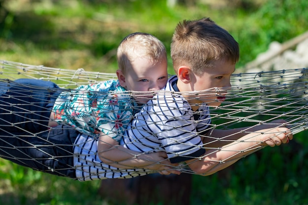 Two boys in a hammock in the garden.