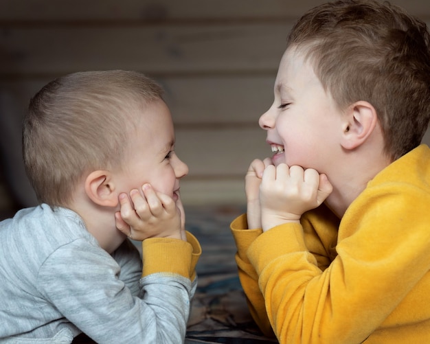 Two boys look at each other and smile