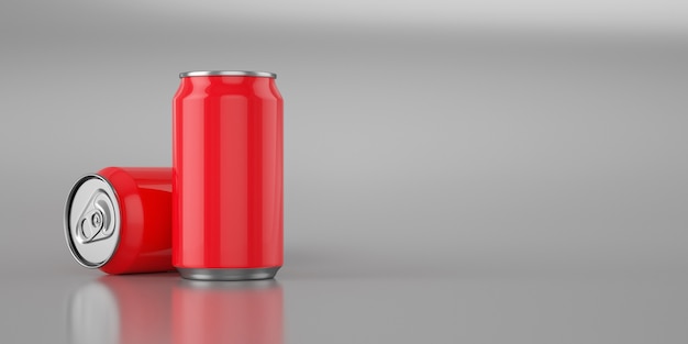 Two bright red cola cans on metal