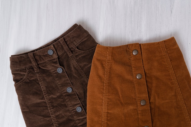 Two  brown skirts on wood