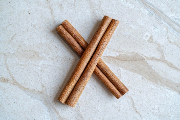 Two brown vegeterian cinnamon sticks lying on the table spicy and healthy top view