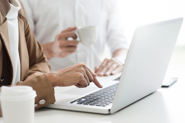 Two business executives at a cafe or working space and discussing a project