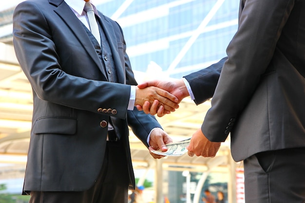 two business man hold hands when change benefits