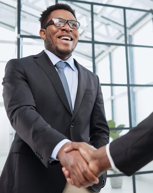 Two business men shaking hands together after successful meeting