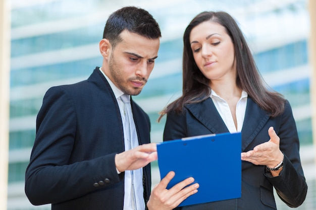 Two business people discussing about some documents