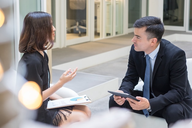 Two business people discussing and talking in the office.