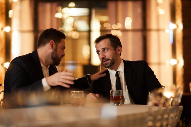 Two Business People Drinking in Restaurant