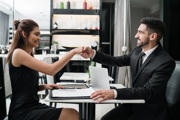 Two business people having meeting and shaking hands.