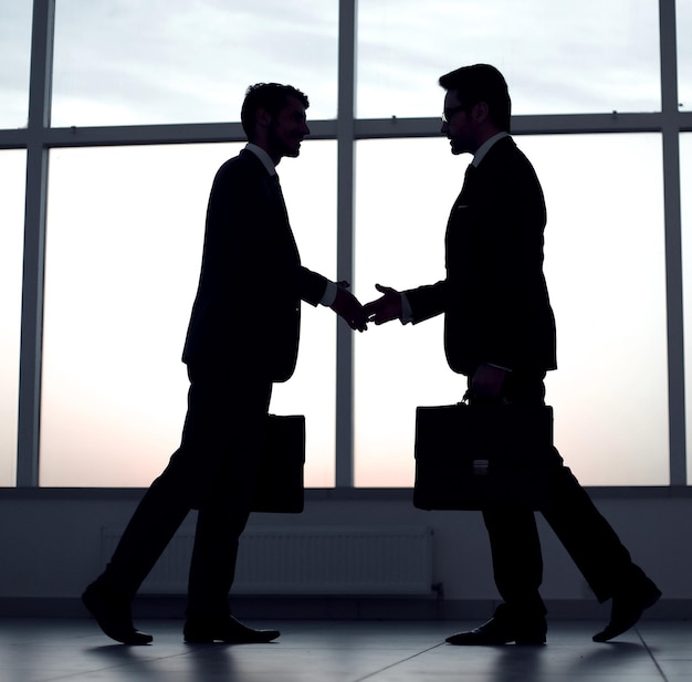 Two business people holding out their hands for a handshakephoto with copy space