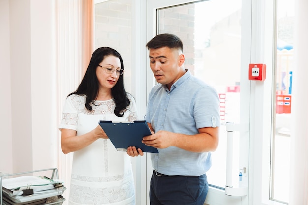 Two business people a man and a woman discuss work in the office