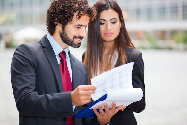 Two business people reading some documents