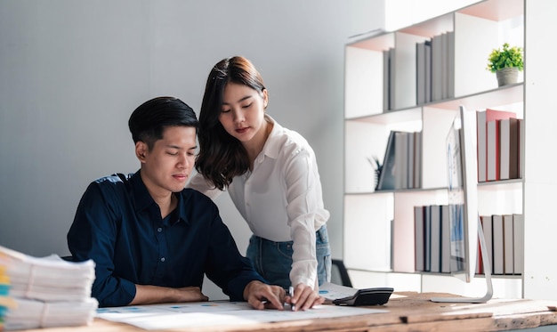 Two business people talk project strategy at office meeting room Businessman discuss project planning with colleague at modern workplace while having conversation and advice on financial data report