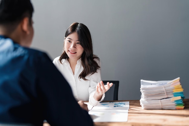 Two business people talk project strategy at office meeting room Businessman discuss project planning with colleague at modern workplace while having conversation and advice on financial data report