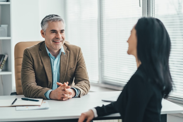 The two business people talking at the office table