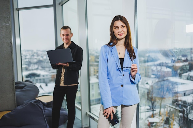 Two business people working remotely online using a laptop Colleagues work remotely in the workspace