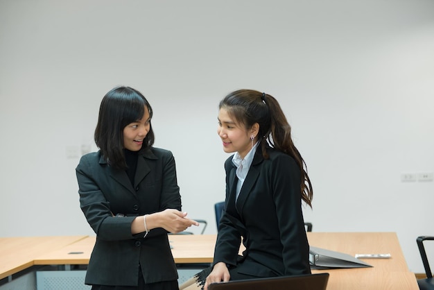 Two business woman serious about work in the officeDiscuss about project of workThailand people