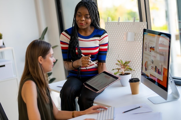 Two business woman working in her office