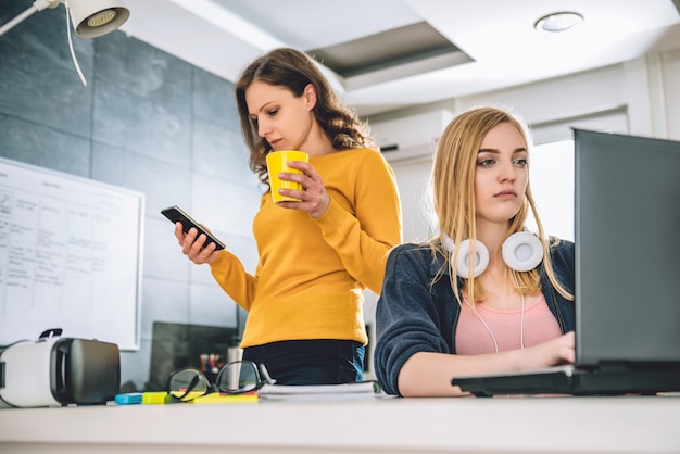 Two business woman working at the office