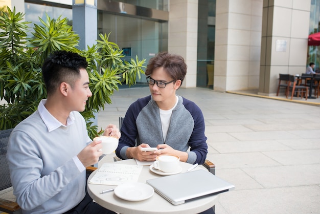 Two businessman having a casual meeting or discussion in the city.